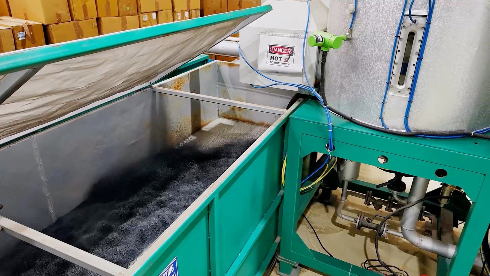 Close view of material moving through factory equipment