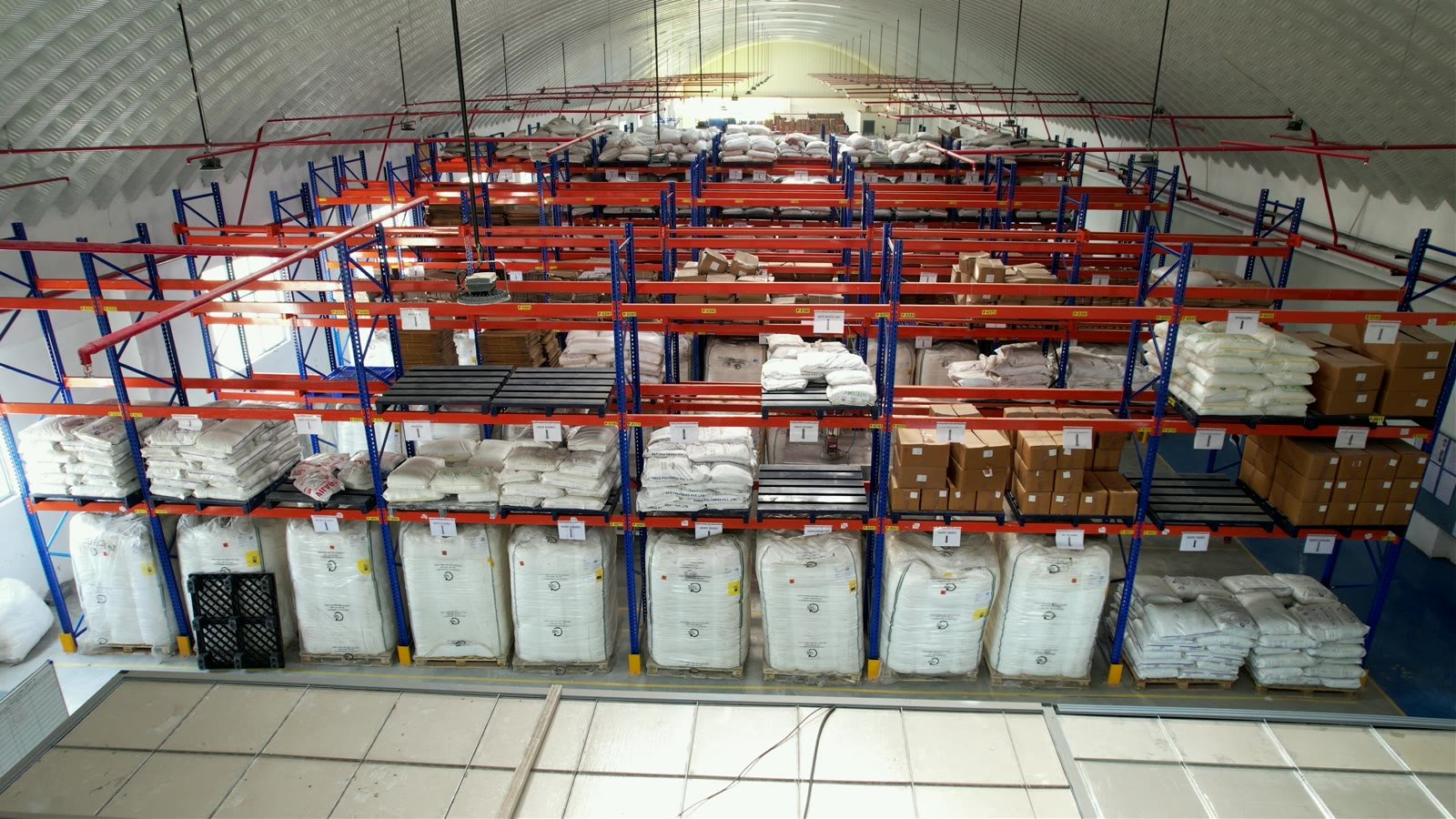 Wide view across organised factory storage racks